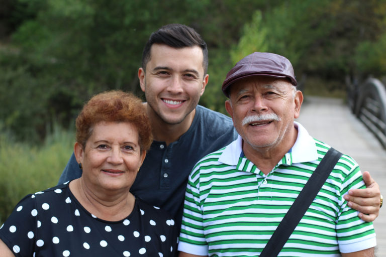Hispanic man with his parents outdoors